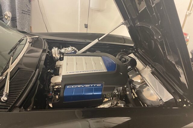 A car engine with the hood open.