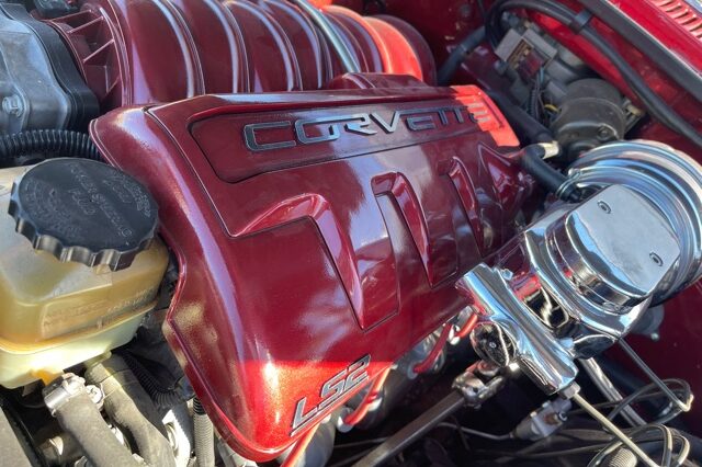 A red car engine with the word chevy on it.